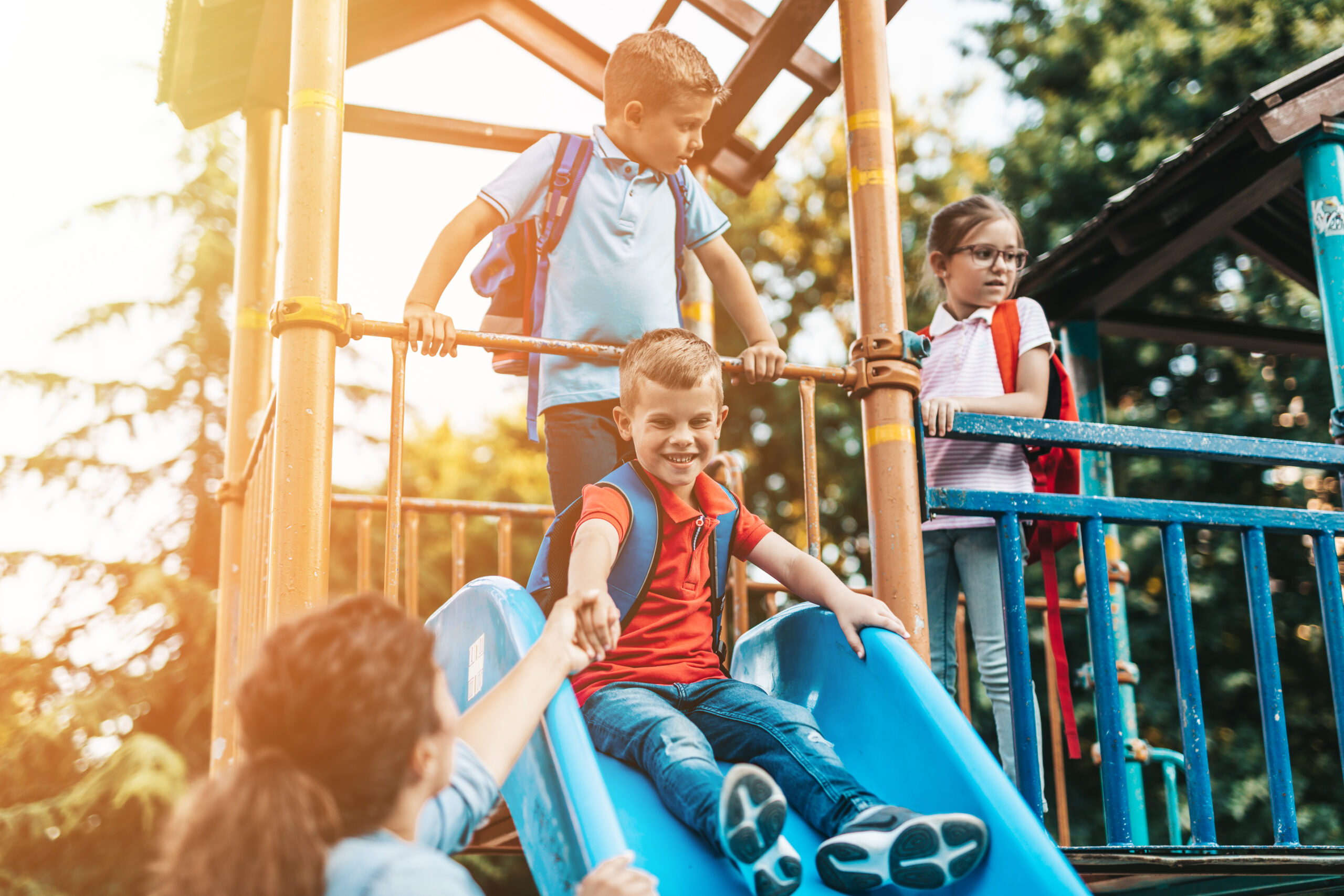 School children playing on the slide.
